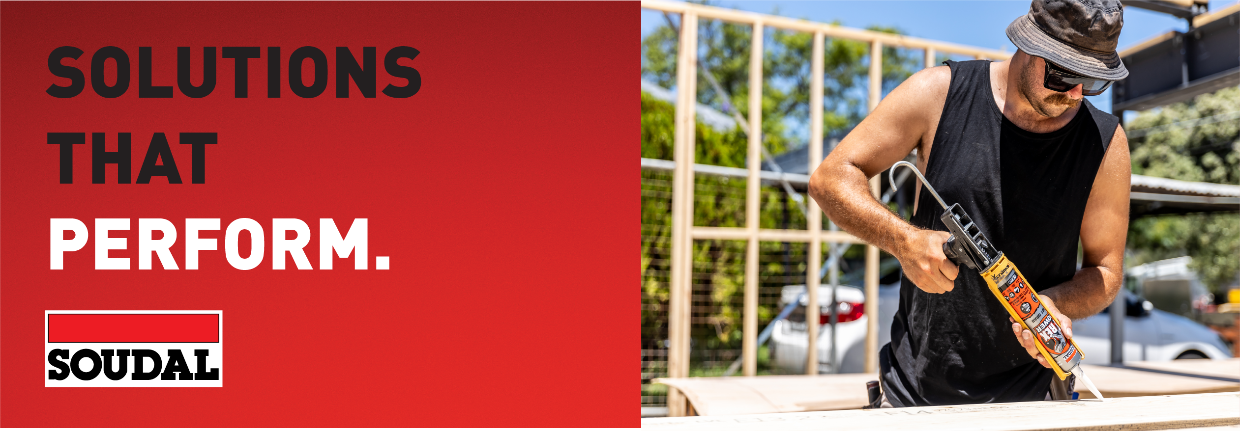The image is a promotional banner for Soudal. On the left, bold text reads “SOLUTIONS THAT PERFORM.” with the Soudal logo underneath. On the right, a man in a black tank top and hat is applying a Soudal sealant at a construction site